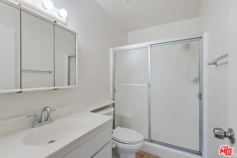a bathroom with a toilet a sink and a mirror
