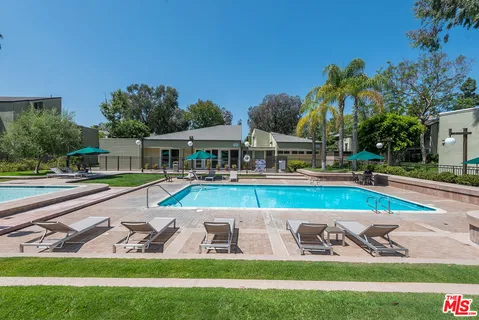 a view of a house with swimming pool and yard