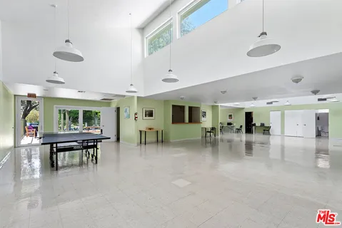 a view of a table and chairs in patio and a yard