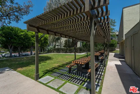 a view of a house with swimming pool and sitting area