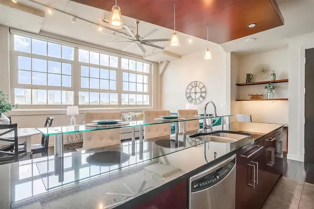 a kitchen with granite countertop a sink stove and cabinets