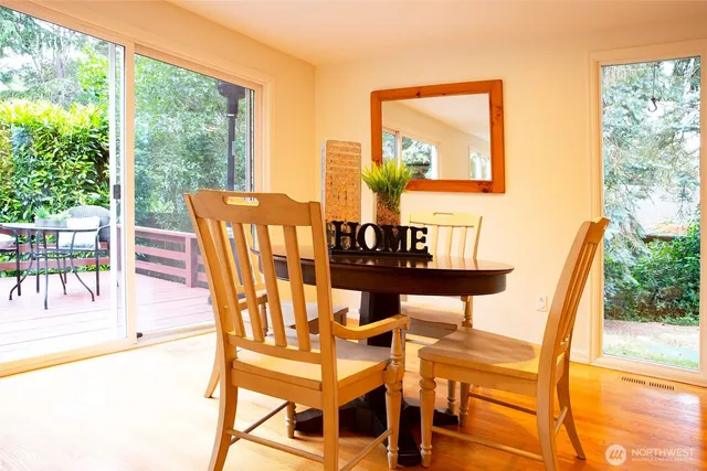a deck with hardwood table and chairs