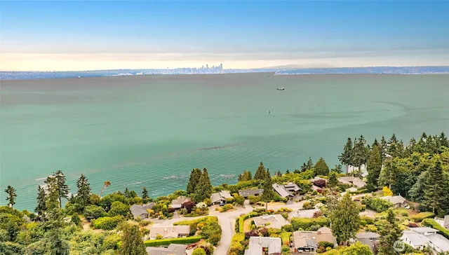 a front view of house with yard and trees around