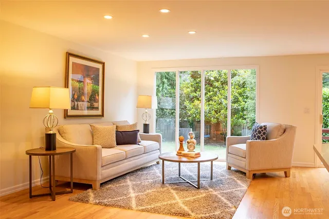 a dining room with furniture and large windows