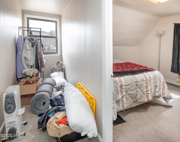 a bedroom with a bed and a mirror