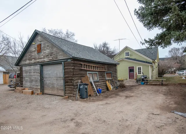 a view of a house with large space and a car parked area