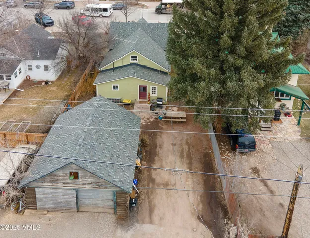 an aerial view of a house with a yard