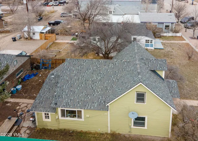 an aerial view of a house with a yard