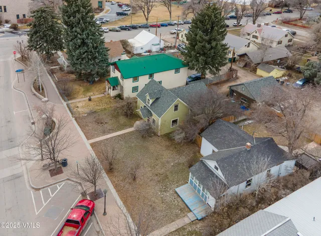 an aerial view of a house with a yard