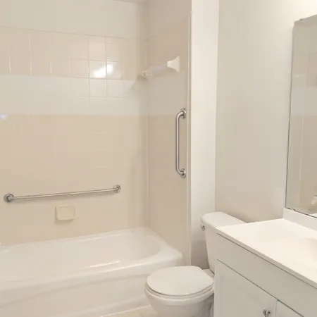 a bathroom with a toilet and a bath tub