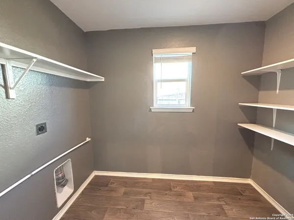 a view of a room with rack on the wall and a window