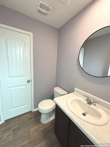 a bathroom with a sink a toilet and mirror