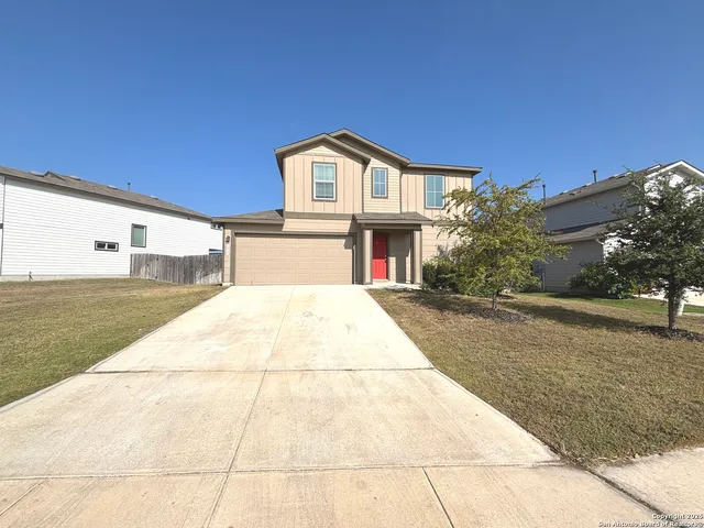 a view of house with backyard and tree