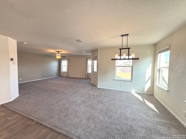 a view of empty room with window and fireplace