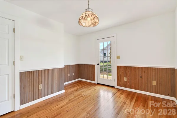 a view of a room with wooden floor