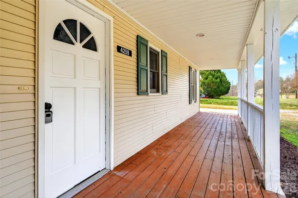 a view of a door of a house with a porch