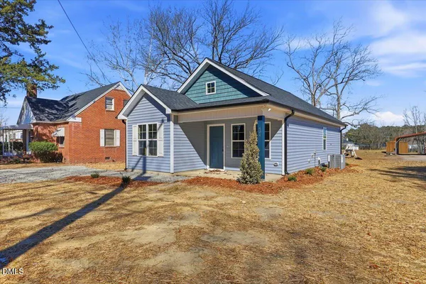 a white toilet sitting next to a bath tub