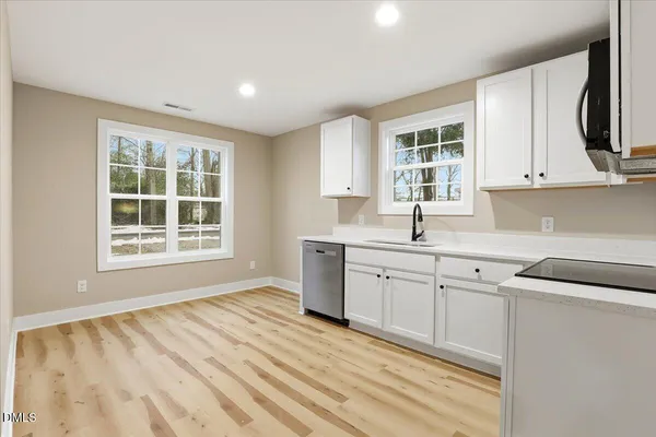 a view of a kitchen with a sink and dishwasher