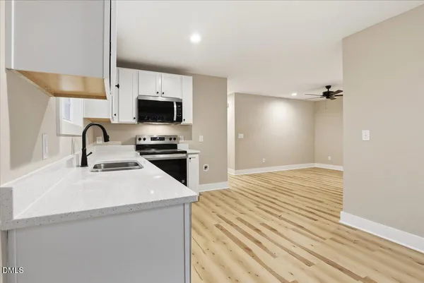 a kitchen with a sink appliances and cabinets