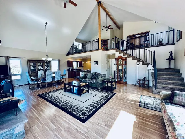 a living room with lots of furniture and wooden floor