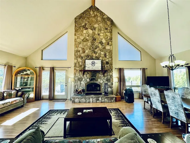 a dining room with furniture and wooden floor
