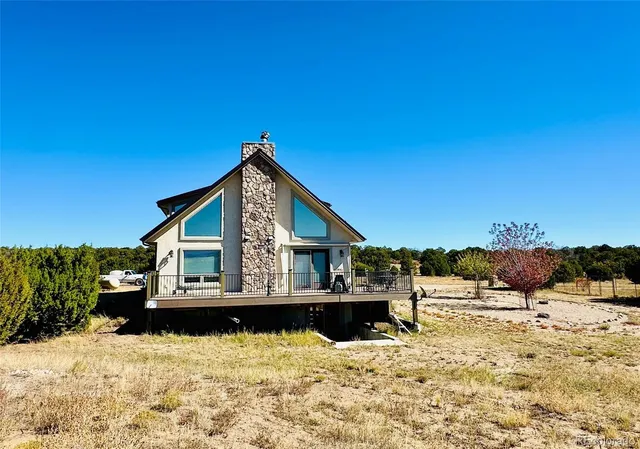 a bathroom with a granite countertop sink a mirror and a shower