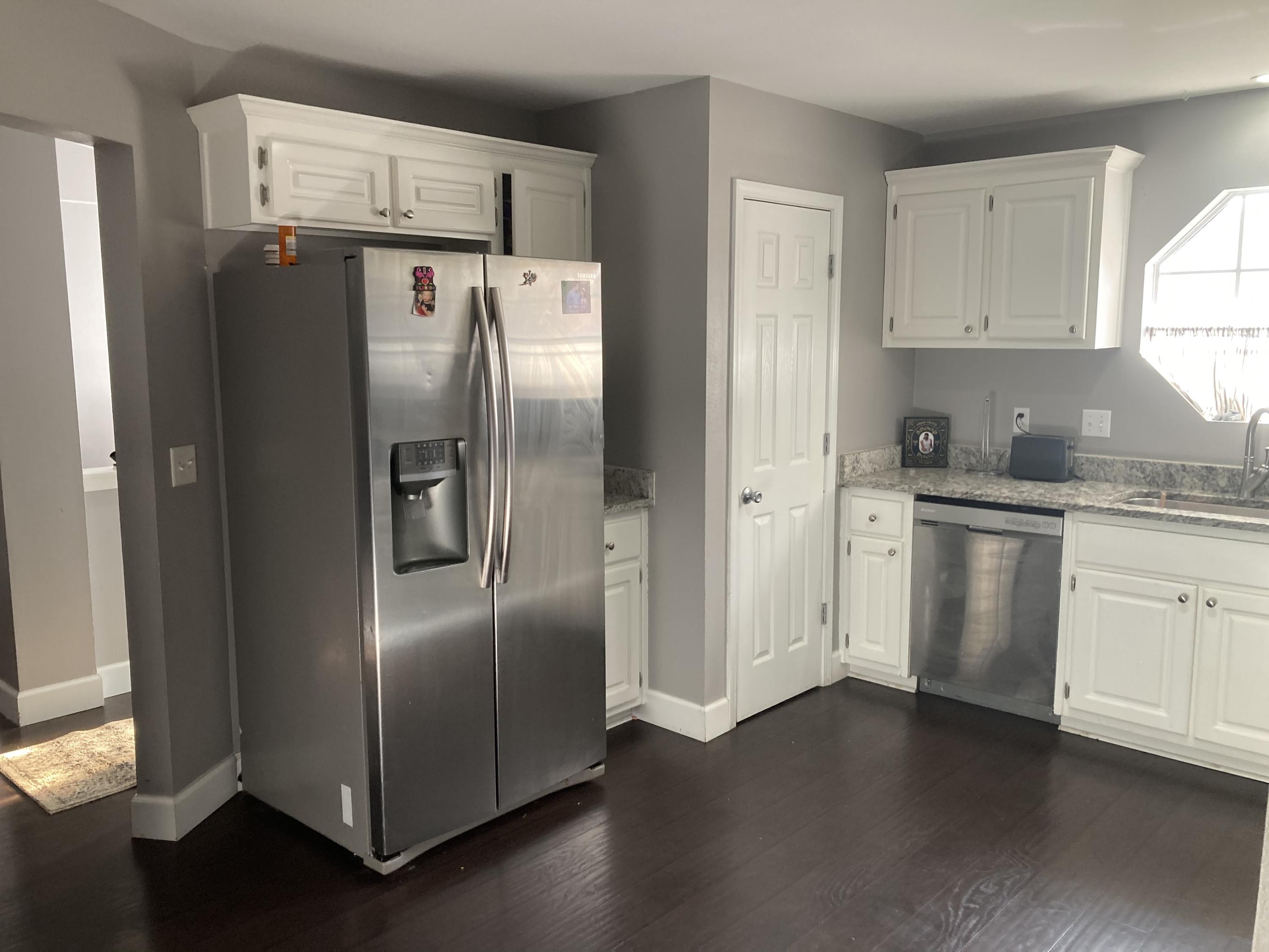 2717 Augustus Road Navarre, FL 32566 - Photo 6 of 9 a kitchen with stainless steel appliances a refrigerator sink and cabinets