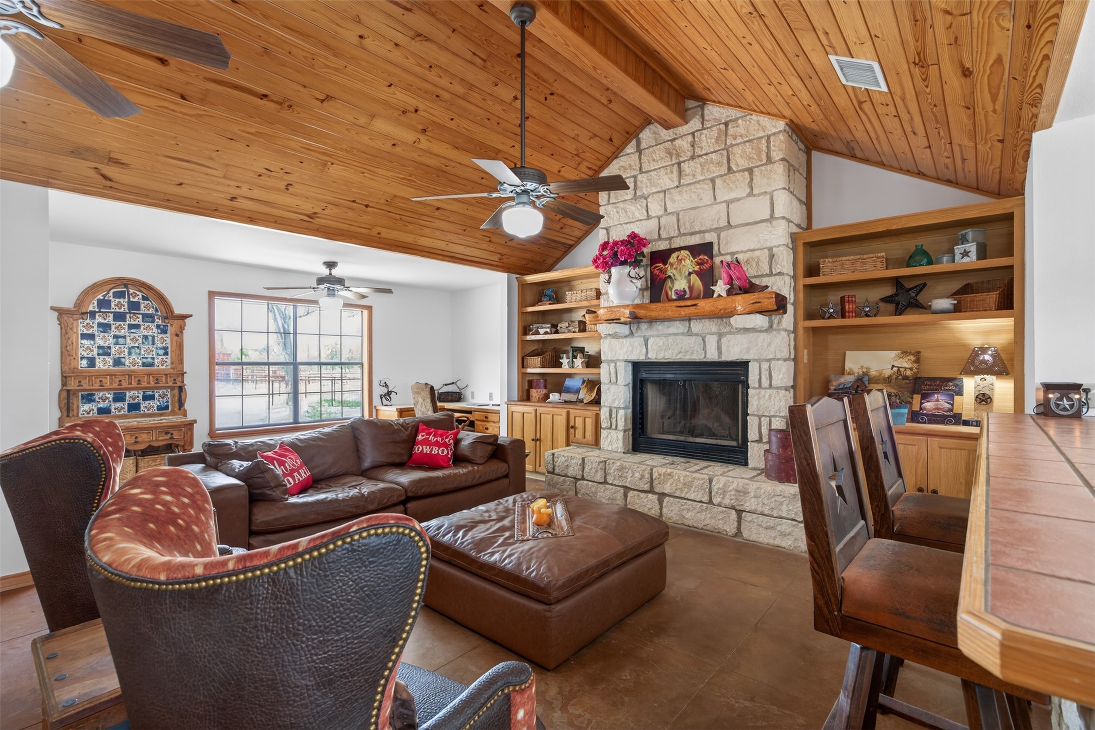 1077 Burdette Wells Road Lockhart, TX 78644 - Photo 13 of 38 a living room with furniture a fireplace and a table