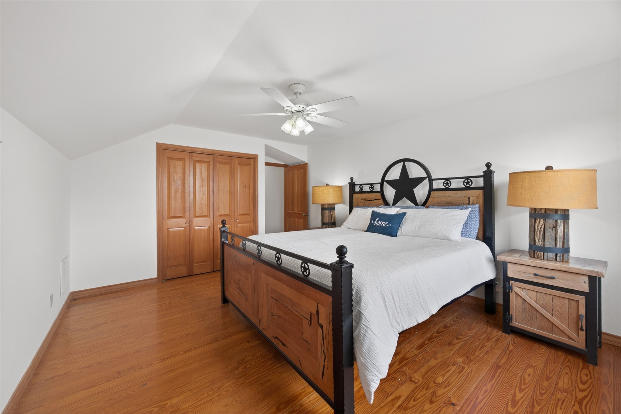 1077 Burdette Wells Road Lockhart, TX 78644 - Photo 18 of 38 a bed sitting in a bedroom next to a lamp