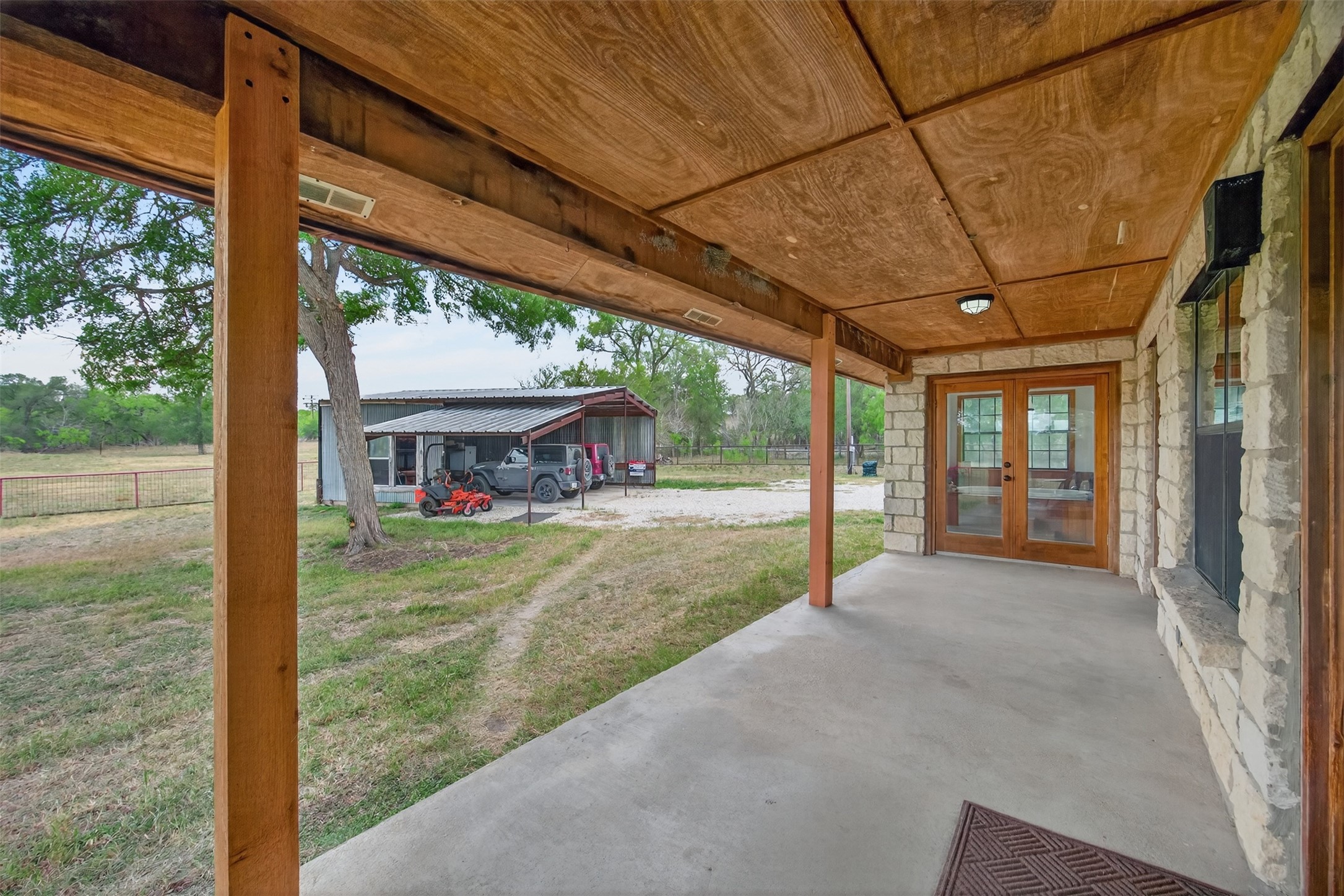 1077 Burdette Wells Road Lockhart, TX 78644 - Photo 24 of 38 a view of a house with backyard and porch