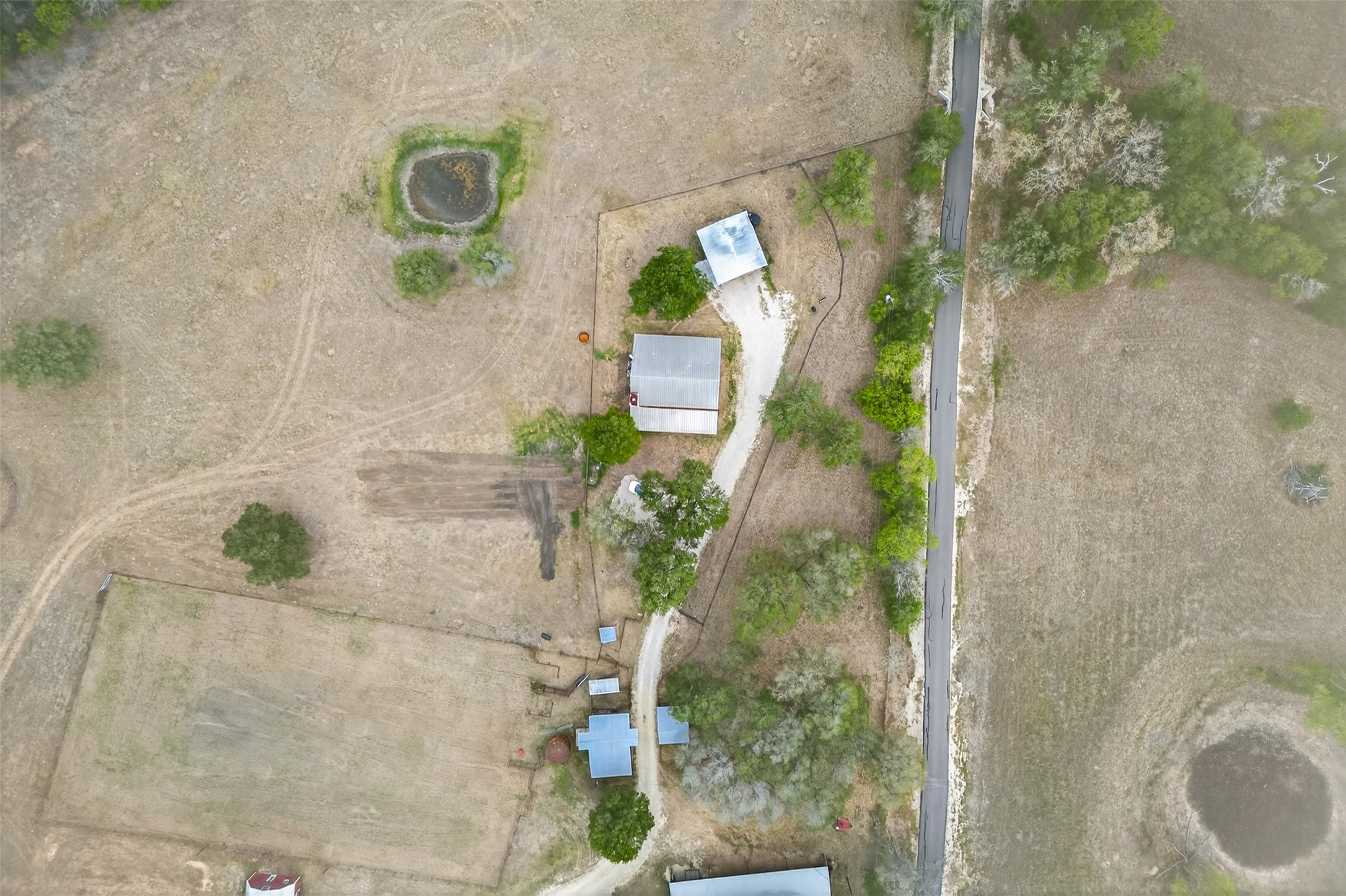 1077 Burdette Wells Road Lockhart, TX 78644 - Photo 3 of 38 an aerial view of a house with a yard and sitting space