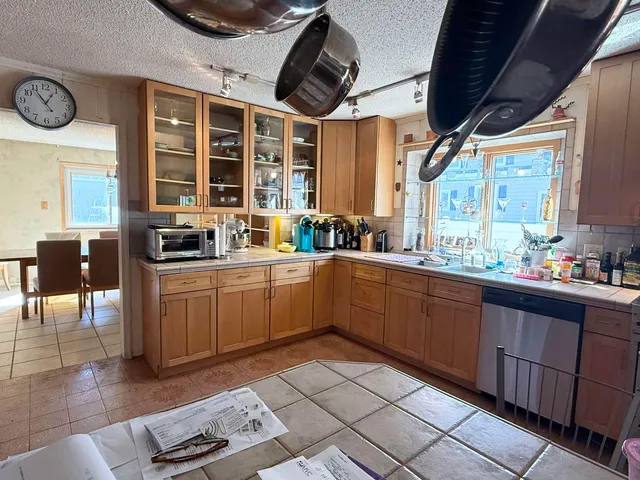 a kitchen with a sink window and cabinets