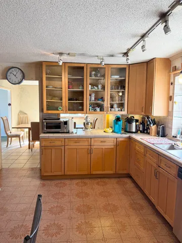 a kitchen with a sink stove and cabinets