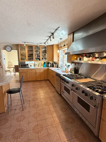 a kitchen with a stove a sink and a refrigerator
