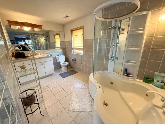 a bathroom with a sink mirror toilet and bathtub