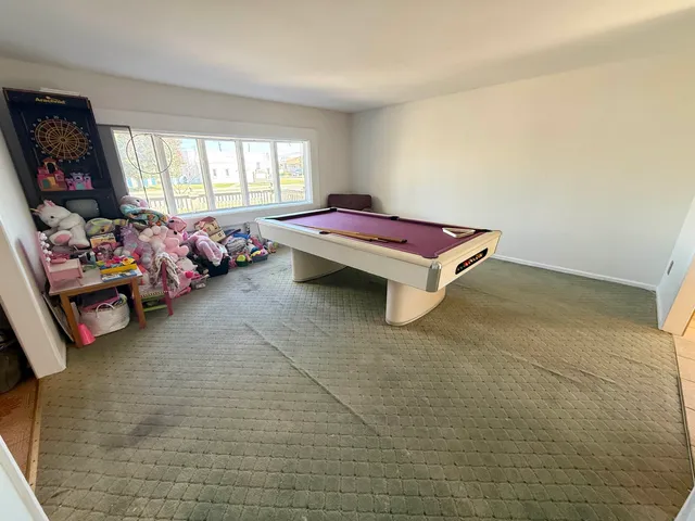 a living room with furniture a window and a flat screen tv