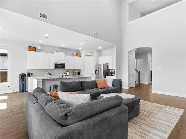 a living room with furniture and kitchen view