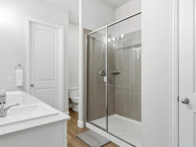 a bathroom with a shower and a sink