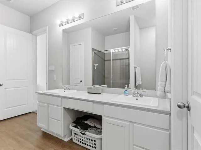 a bathroom with a sink double vanity and a mirror