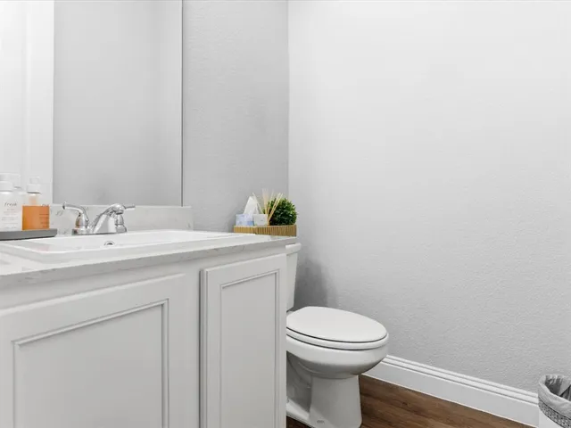 a bathroom with a toilet a sink and mirror