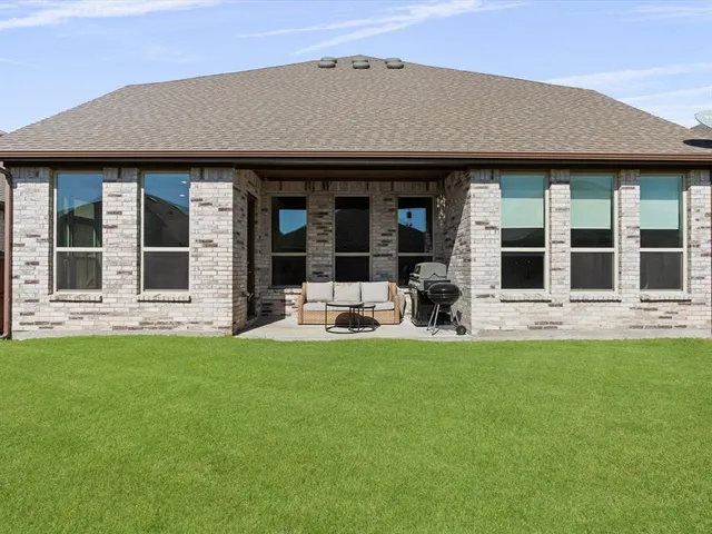 a view of a house with sitting area and garden