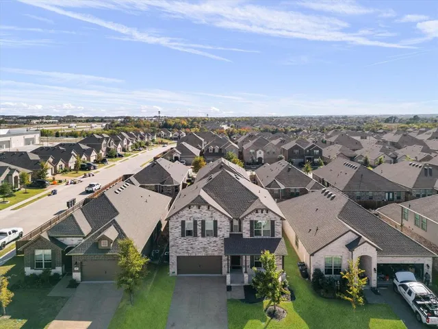 an aerial view of residential houses with outdoor space