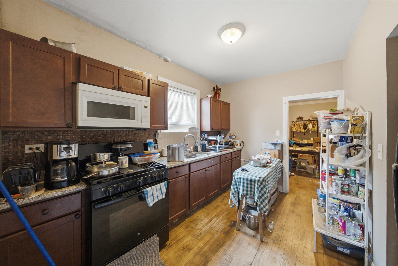 6837 South Morgan Street Chicago, IL 60621 - Photo 5 of 24 a kitchen with stainless steel appliances granite countertop a stove and cabinets