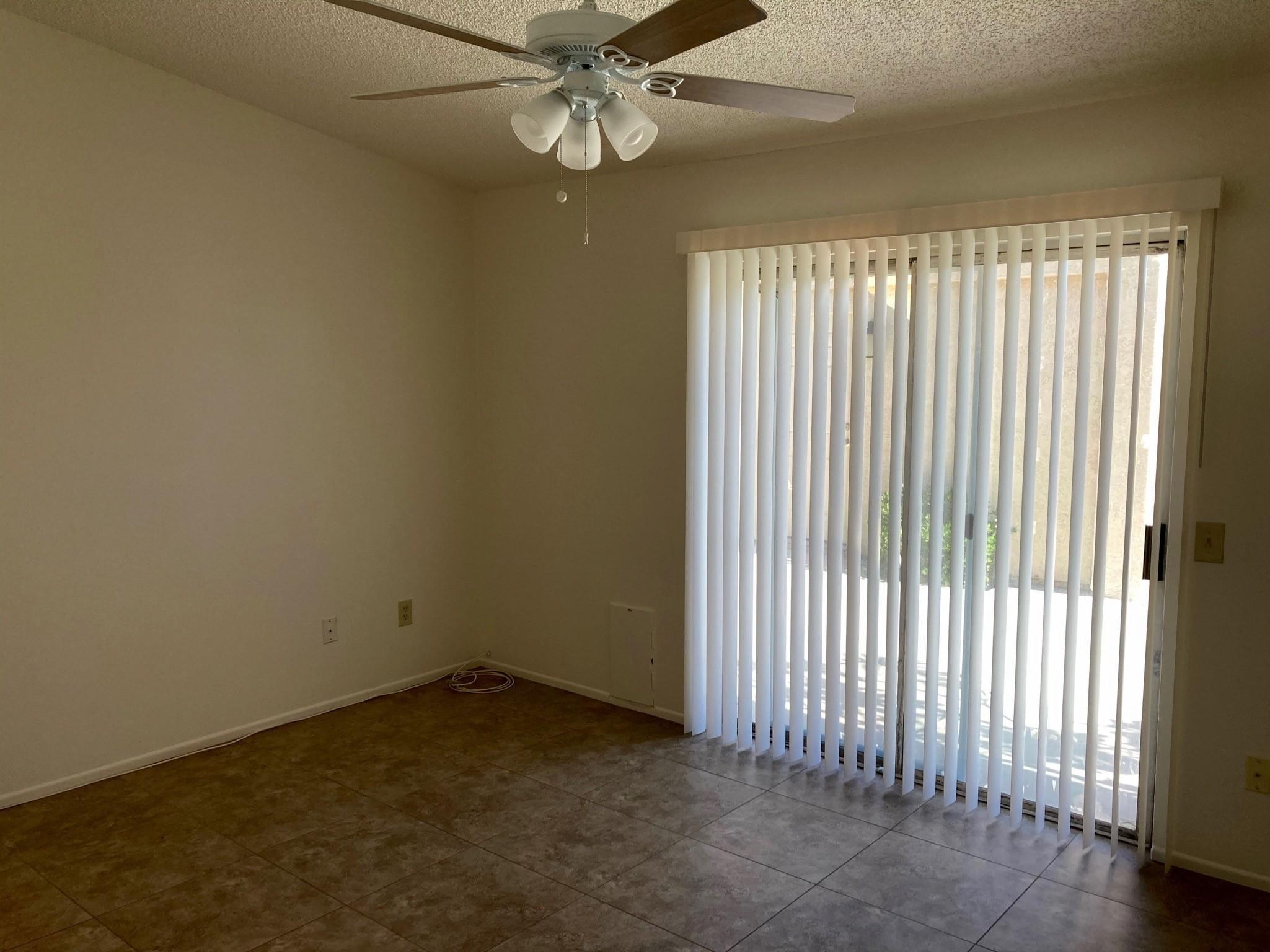 41680 Maroon Town Road, Unit B Bermuda Dunes, CA 92203 - Photo 13 of 19 an empty room with a ceiling fan and window