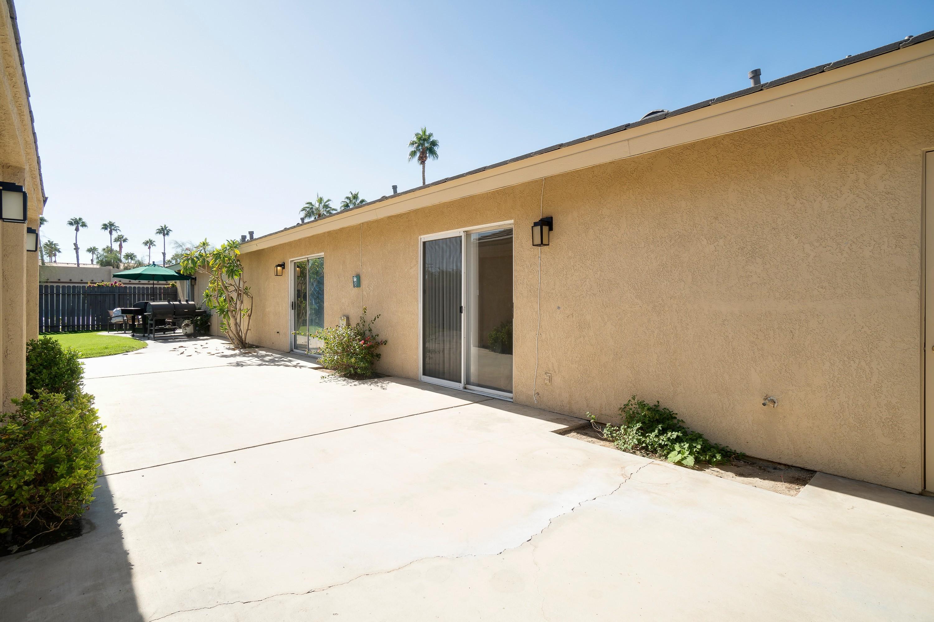 41680 Maroon Town Road, Unit B Bermuda Dunes, CA 92203 - Photo 19 of 19 a white house with a large tree in front of it