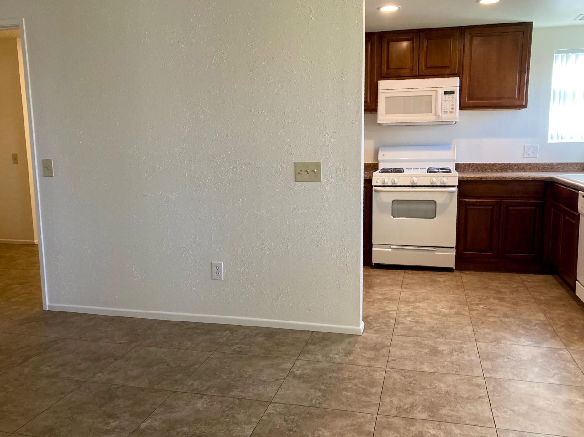 41680 Maroon Town Road, Unit B Bermuda Dunes, CA 92203 - Photo 5 of 19 a kitchen with a stove top oven and sink
