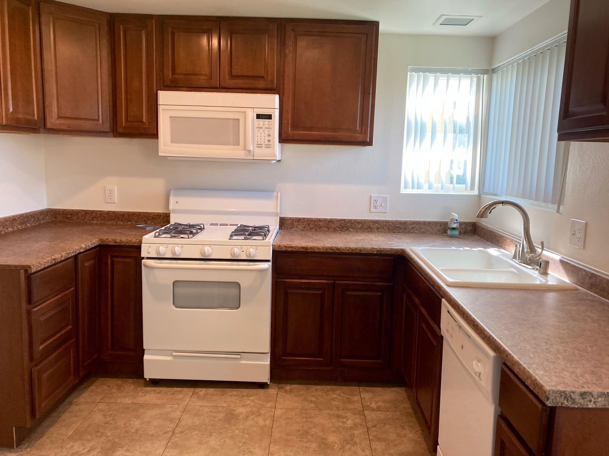 41680 Maroon Town Road, Unit B Bermuda Dunes, CA 92203 - Photo 7 of 19 a kitchen with a sink stove and cabinets