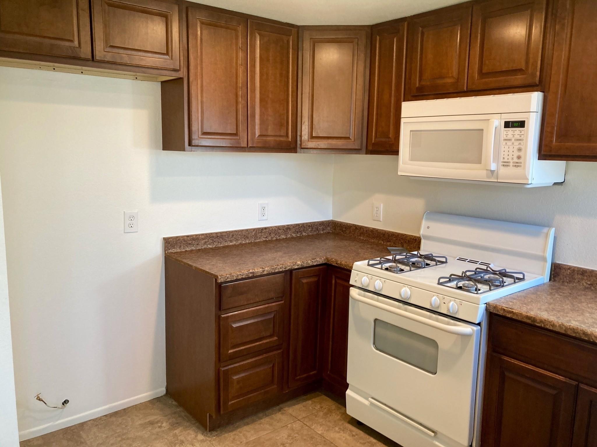 41680 Maroon Town Road, Unit B Bermuda Dunes, CA 92203 - Photo 8 of 19 a kitchen with a stove and a microwave