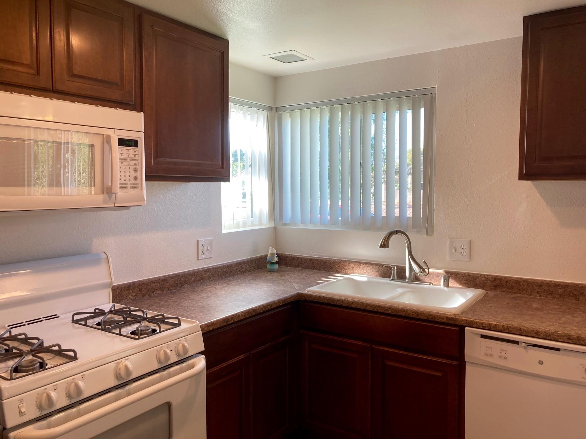 41680 Maroon Town Road, Unit B Bermuda Dunes, CA 92203 - Photo 9 of 19 a kitchen with a sink stove top oven and cabinets