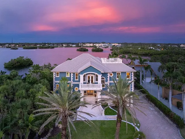 a view of a house with a fountain in front of it